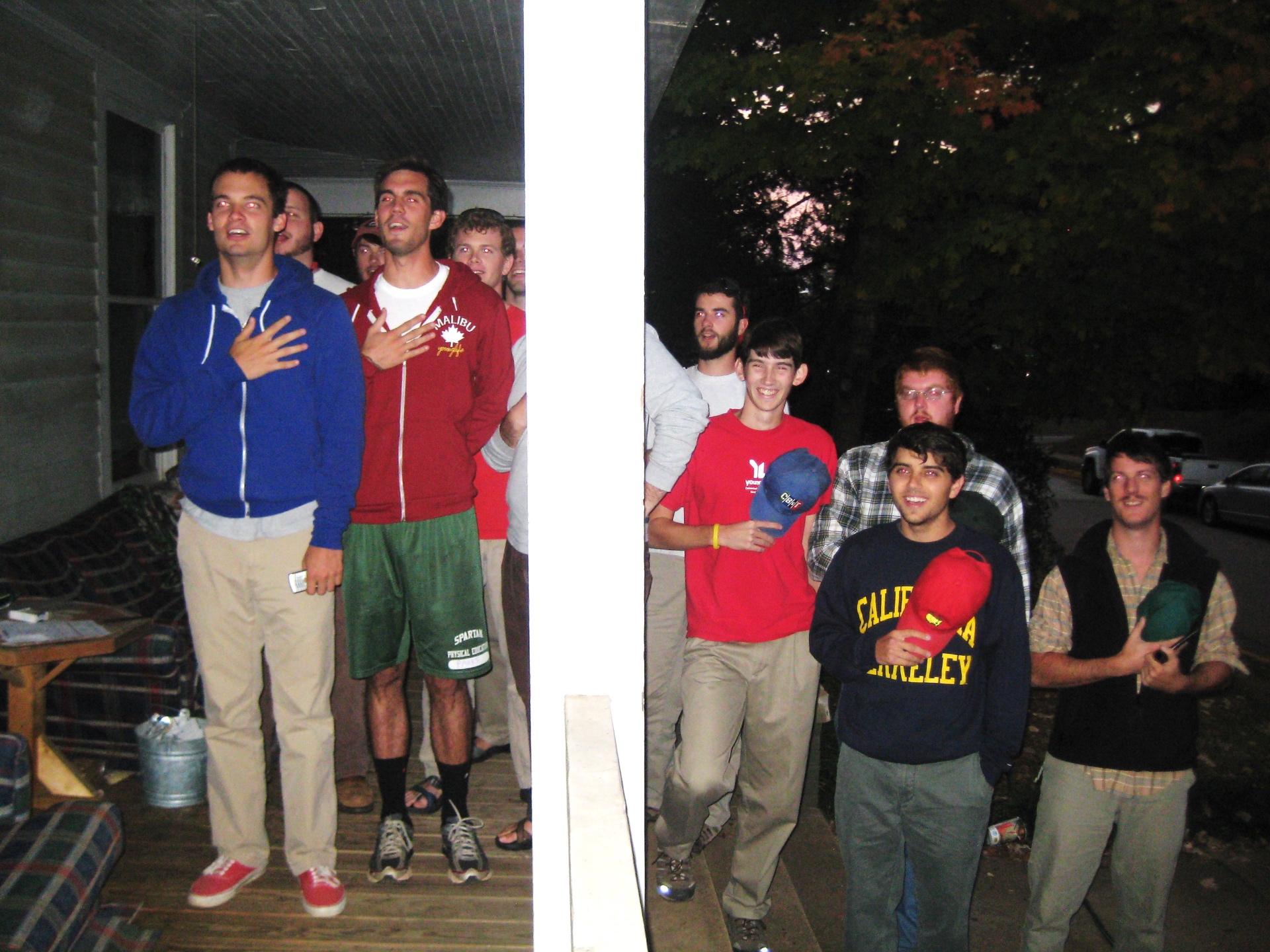 Guys standing on the porch of 120 Springdale at night