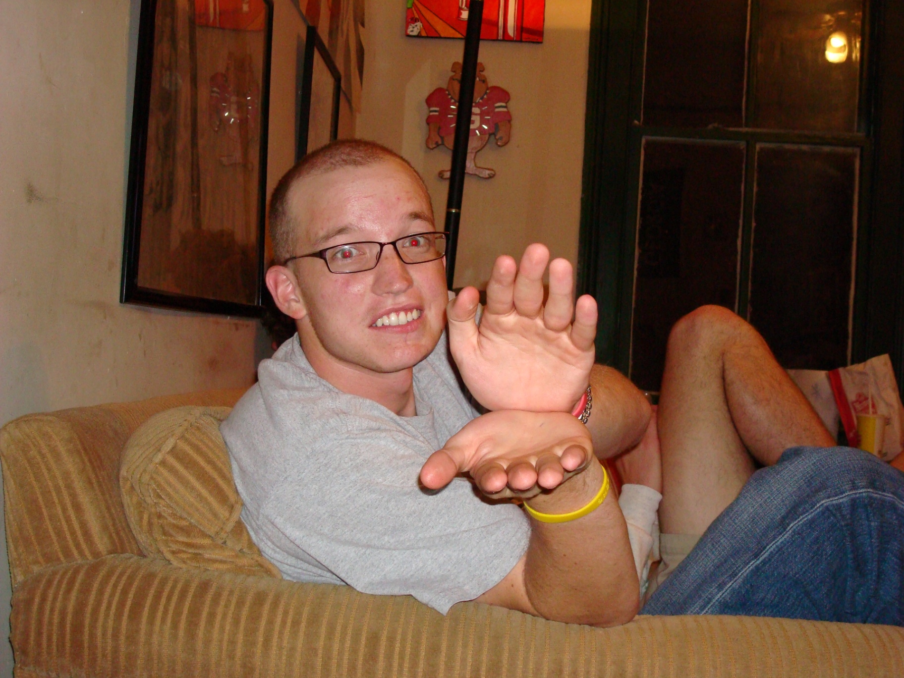 A guy holding his hand toward the camera on the Springdale couch