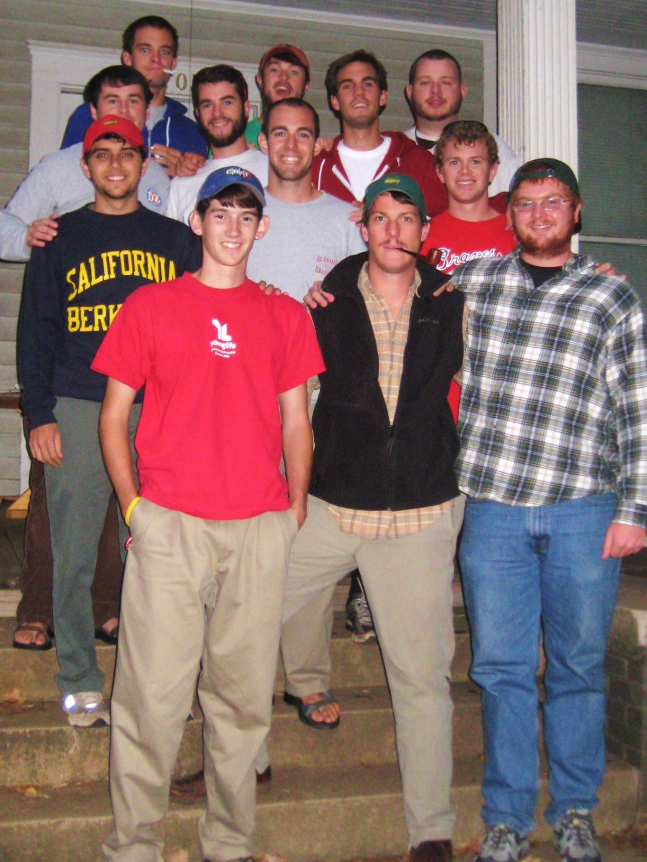 A group of guys posed on the front steps of 120 Springdale at night